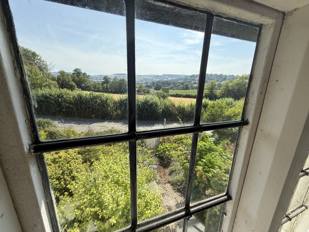 Lot: 90 - SPACIOUS COTTAGE WITH GARDENS FOR UPDATING - View from upper floor window at front
